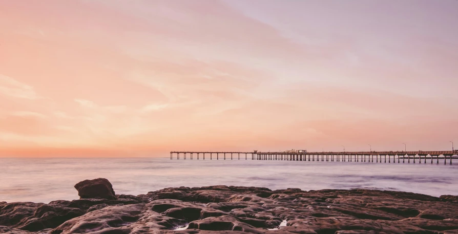 a bridge is visible from the rocks near the water