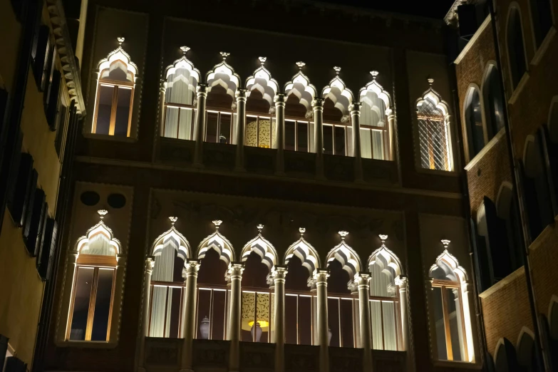 a building with illuminated windows in front of it