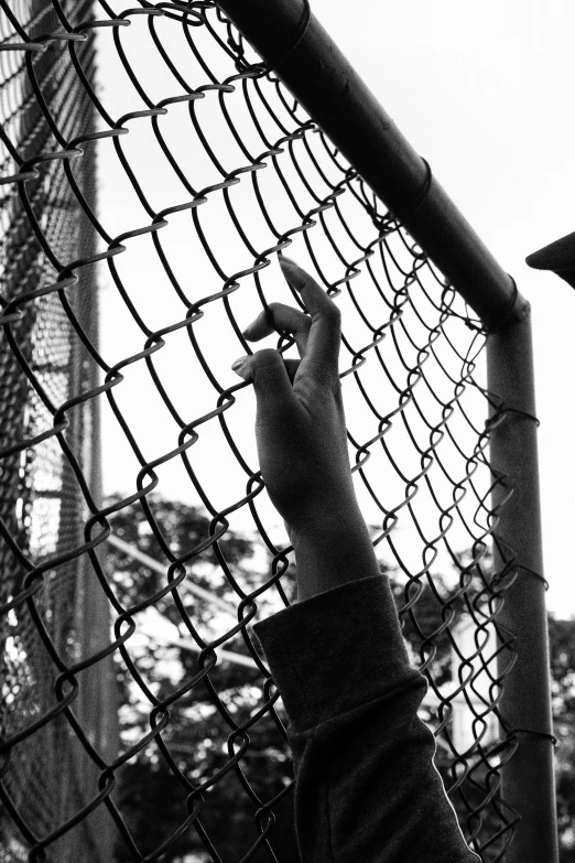 a person is fixing a chain link fence