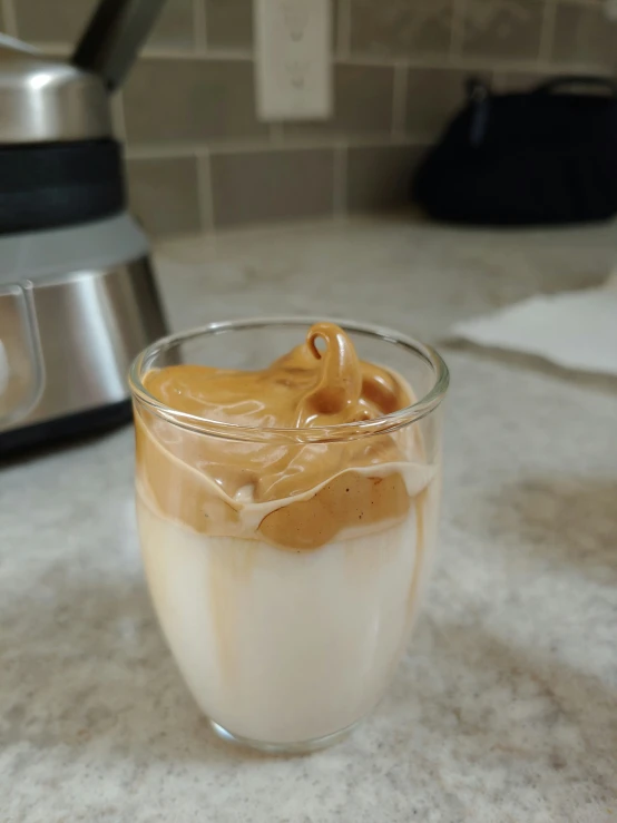 a pitcher of ice cream sits on a counter