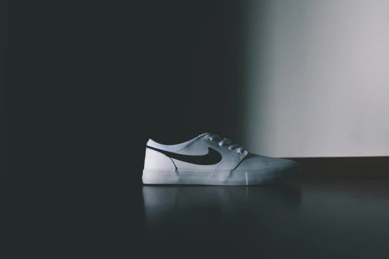 a white sneaker with black nike logo