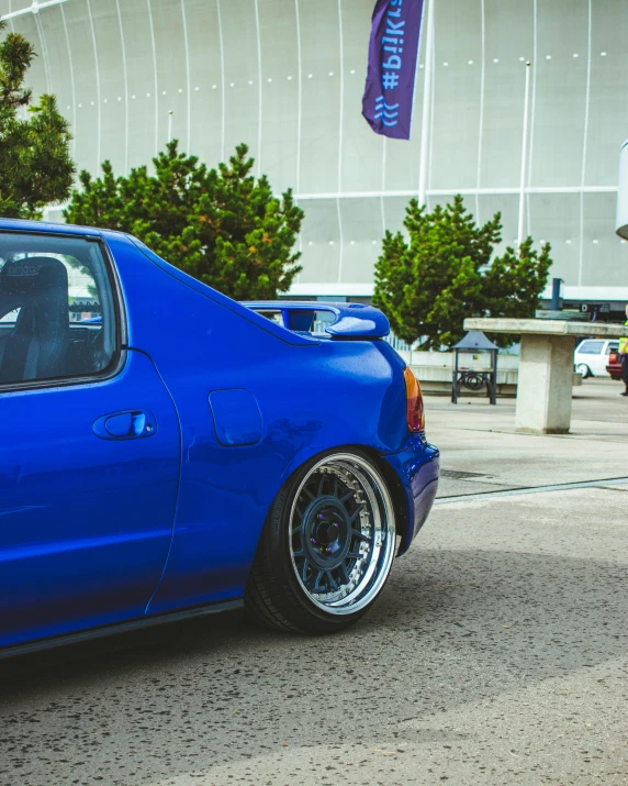 a blue car parked on the side of the road