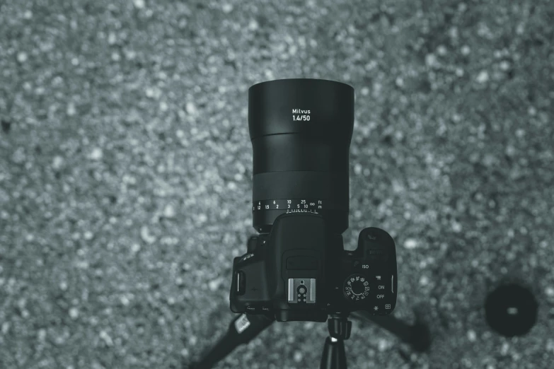a camera is set up on a tripod to view the lens