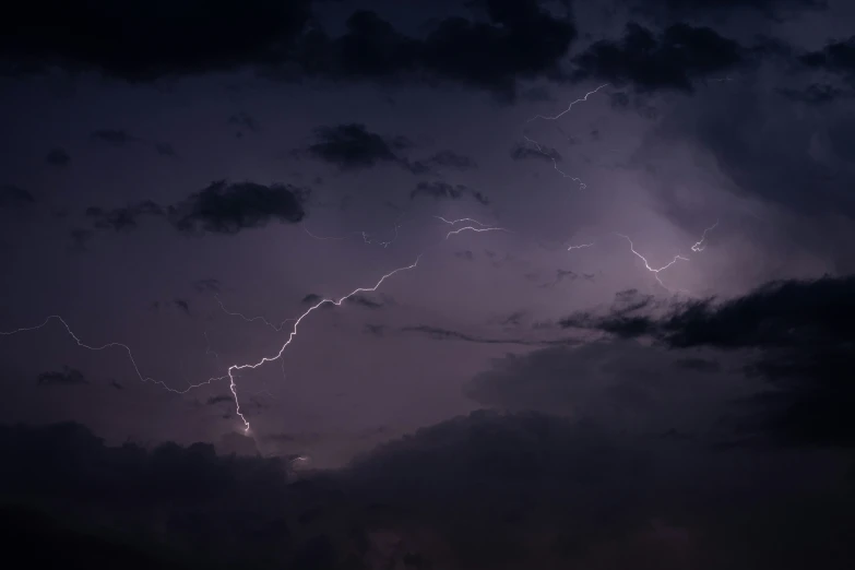 lightning bolts and clouds in the sky during night