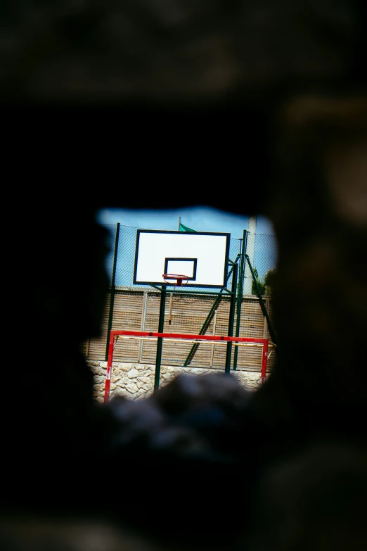 a basketball hoop is seen through a window