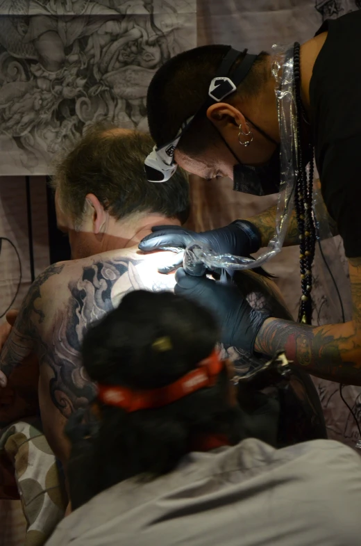 a man with tattoos getting his inked