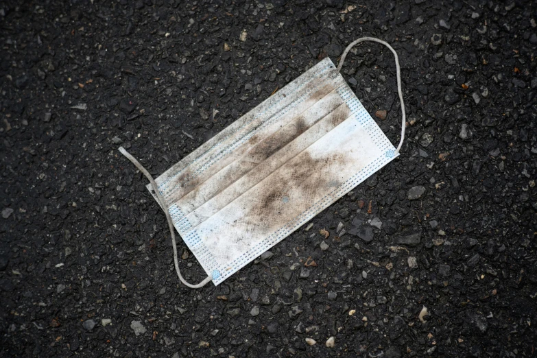 a dust mask on asphalt with no tags