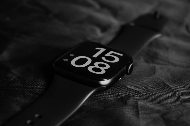 a watch sitting on top of a black object