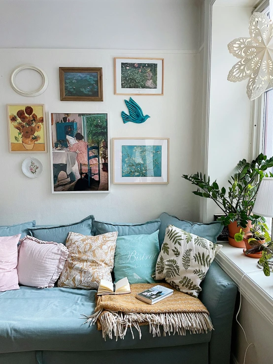 a sofa with various pillows and other decorative items on it