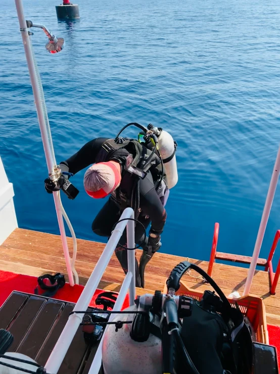 a diving diver is lowered off of the deck