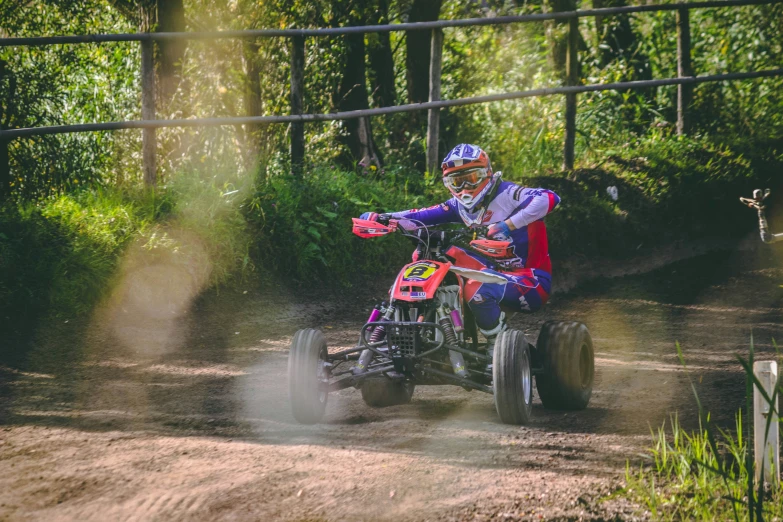 a man riding on the back of a pink four - wheeler