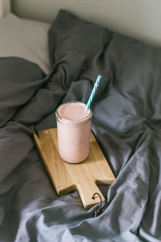 a drink sitting on top of a wooden tray