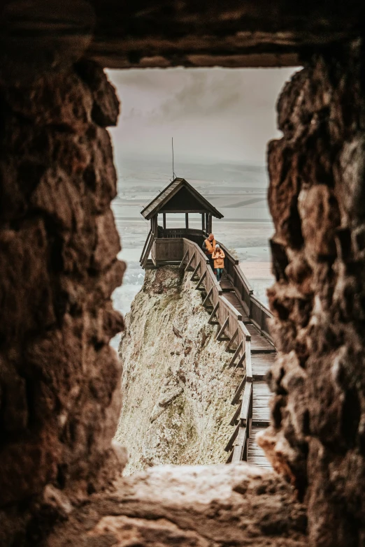 a small shelter on a rocky outcropping above water