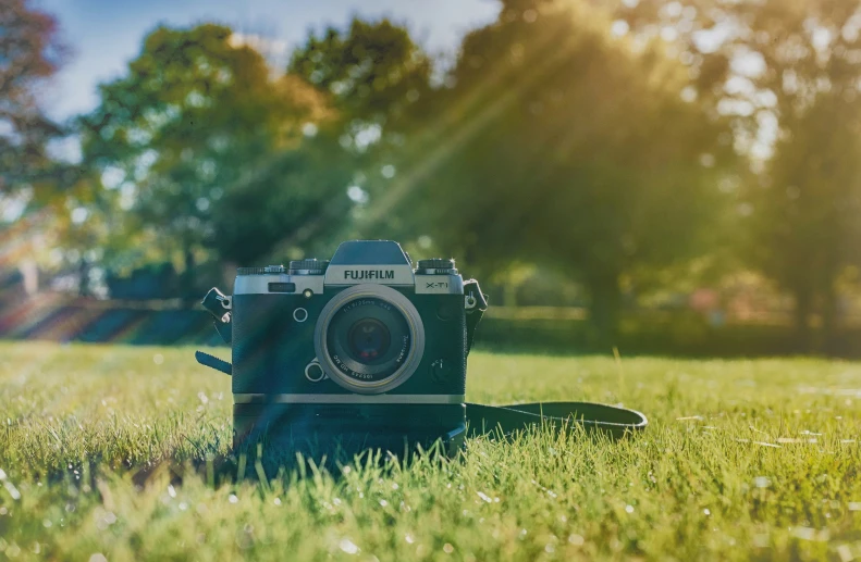 an old camera sits alone in the grass