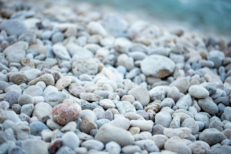 a bunch of small rocks sitting on top of a beach