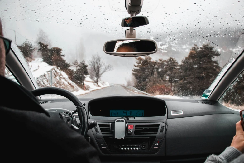 the view of a car and mountains through the windshield