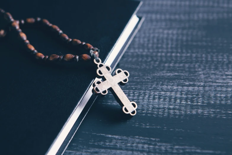 rosary with wood bead necklace on dark background