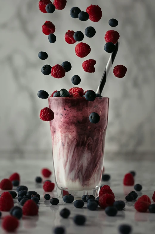 berries and yogurt are being stirred into an ice cream