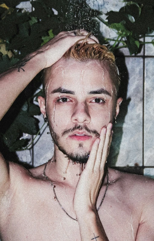 a man with his hair flying while he sits in the bath tub