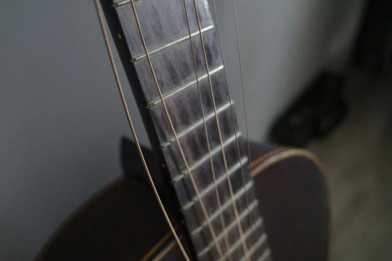 the top side of an acoustic guitar that is showing its strings