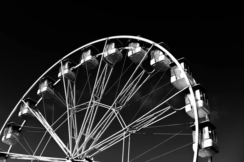 an amut park wheel with lots of people sitting down by