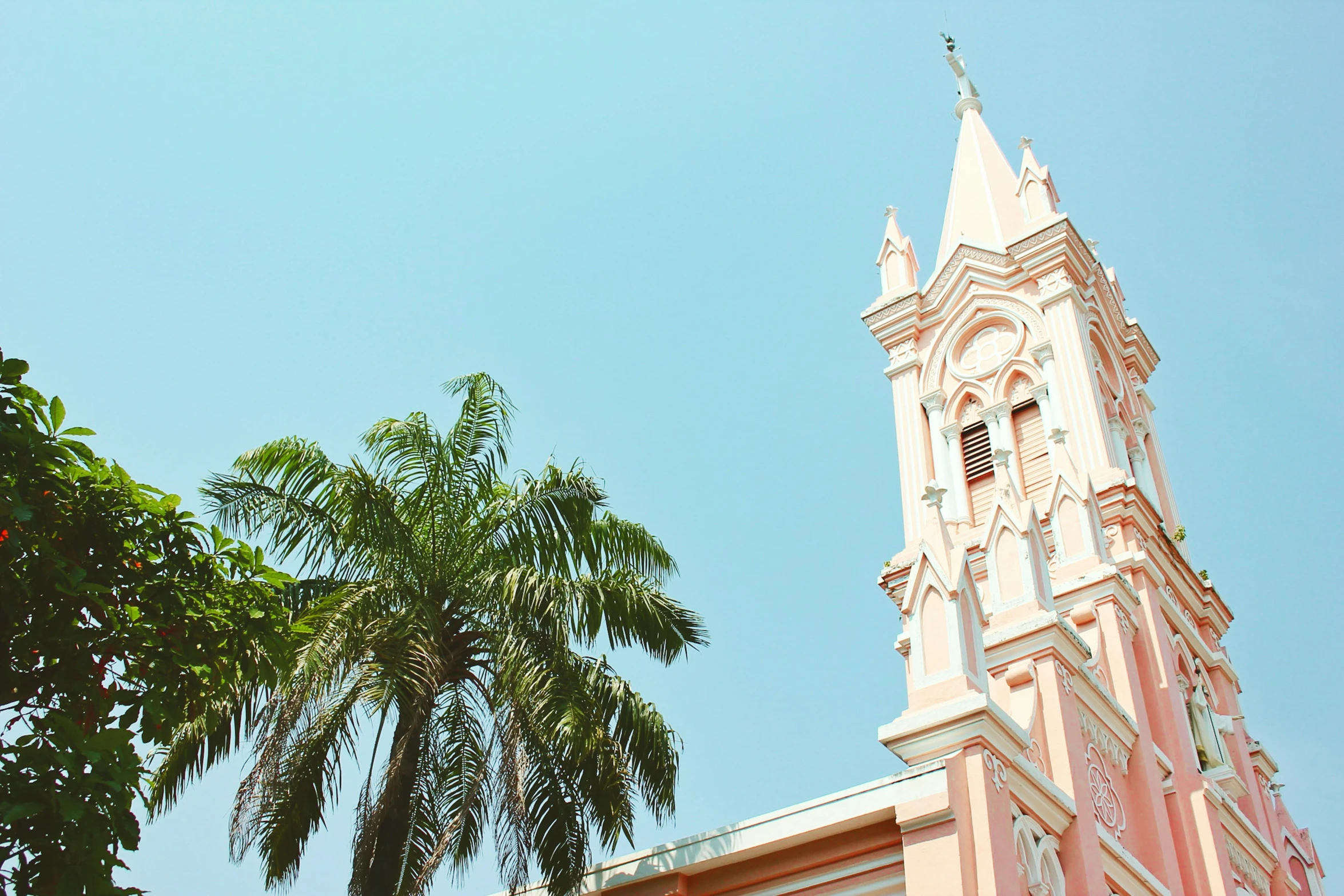 a building with pink trim and a large clock