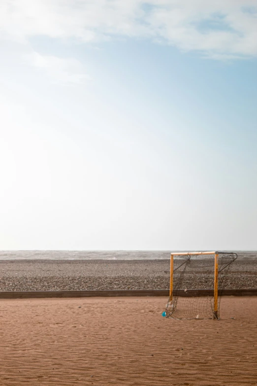 a field with a volleyball net and yellow posts