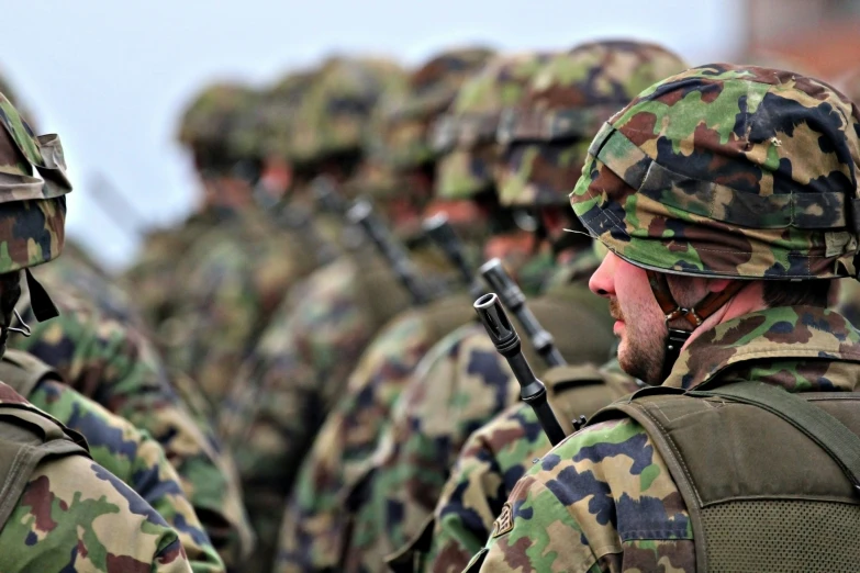 two soldiers are in full gear holding their guns