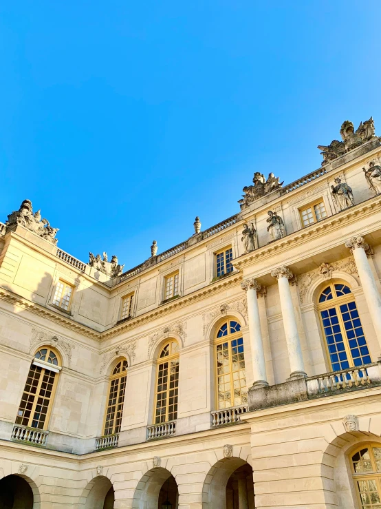 looking up at an ornate building with white stone