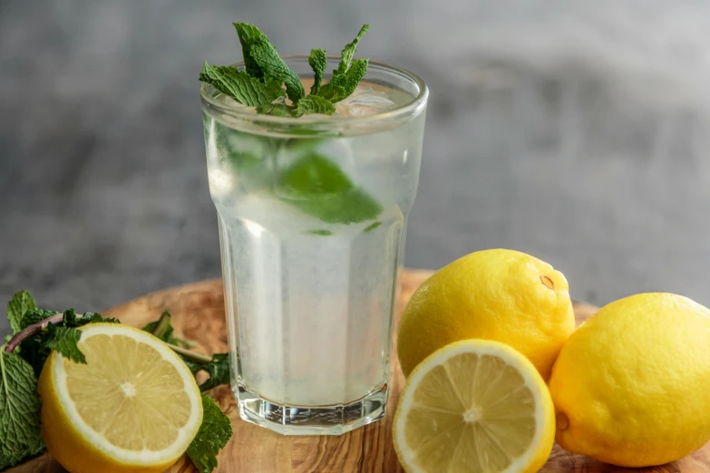 lemons and limes are arranged on a wooden  board