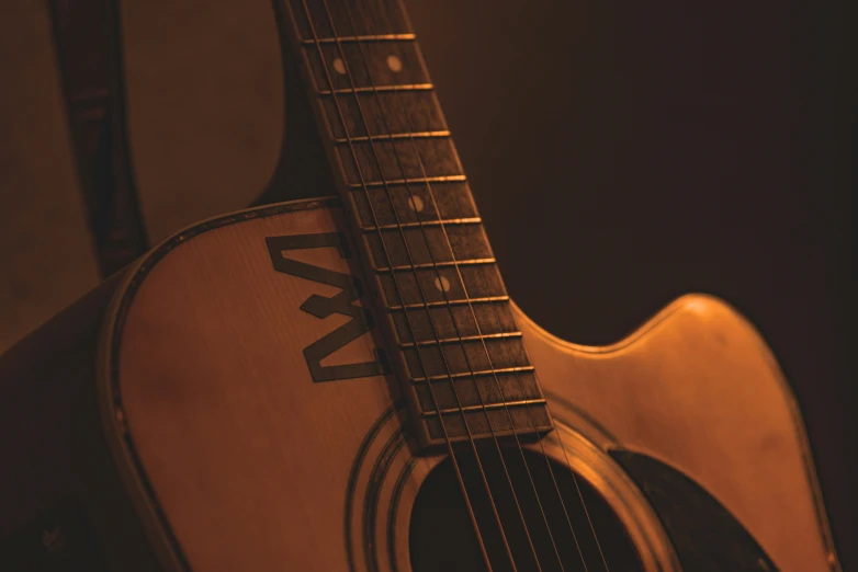 an acoustic guitar sits on a table