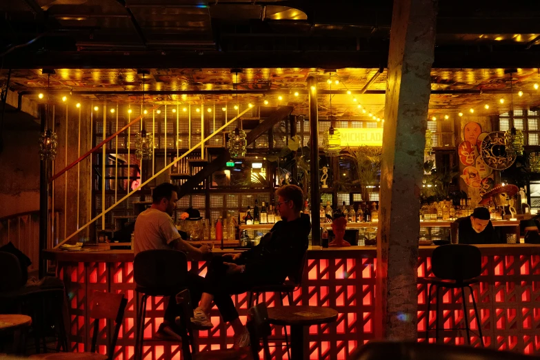people sit around a bar during the night