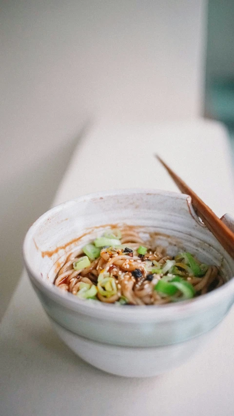 someone with some scissors is eating a bowl of food