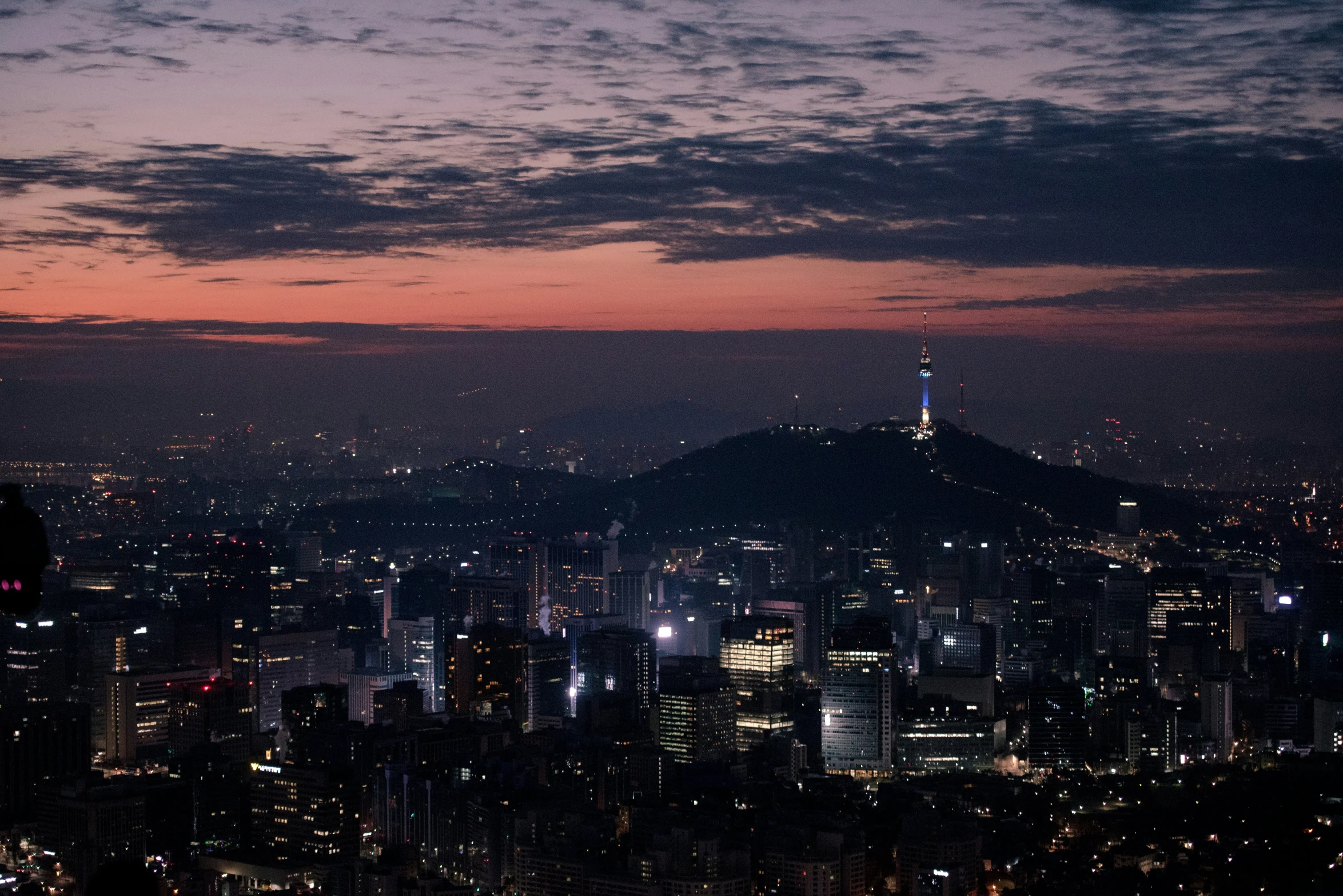 an evening scene of a city lights up the sky