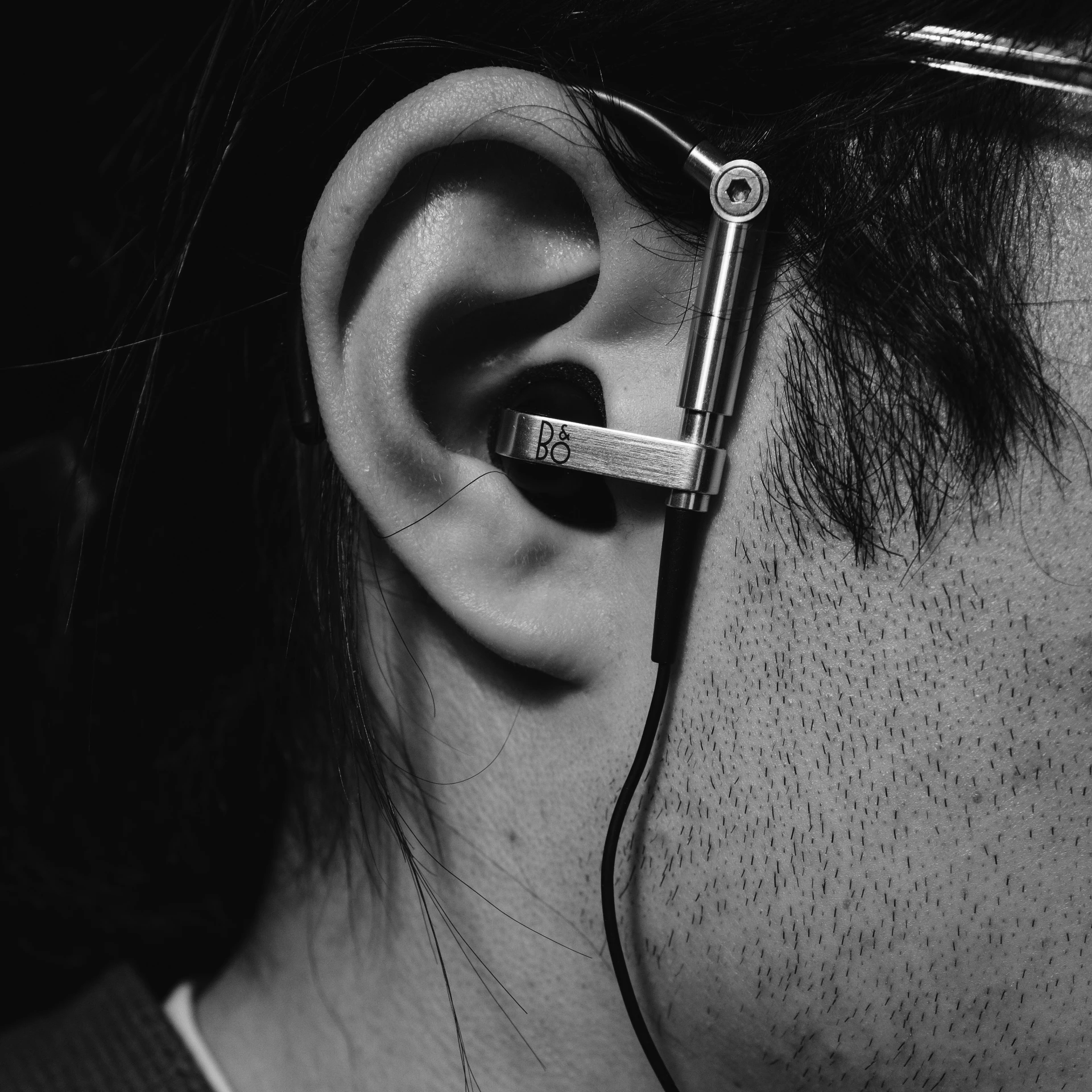 a woman wearing an ear piece next to her head