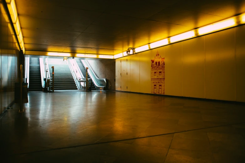 a view of an empty, dirty room and stairs at night