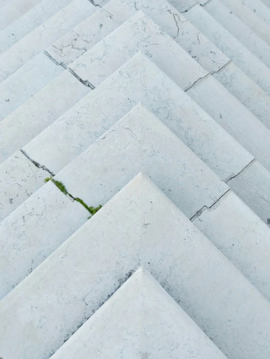 several rows of white tile with a grass in between them