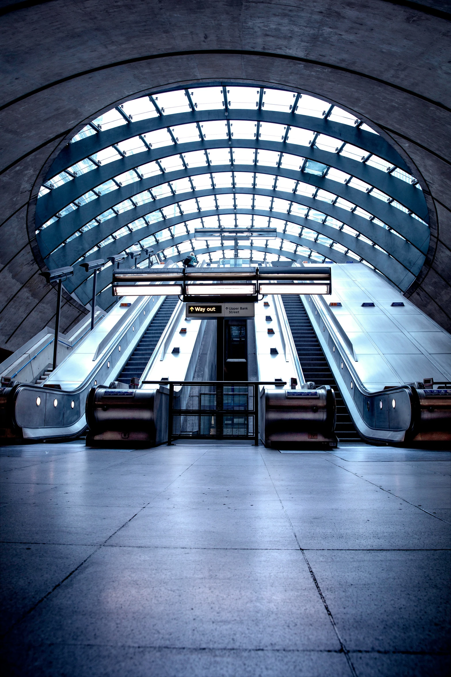 an indoor s of a train station with several escalators