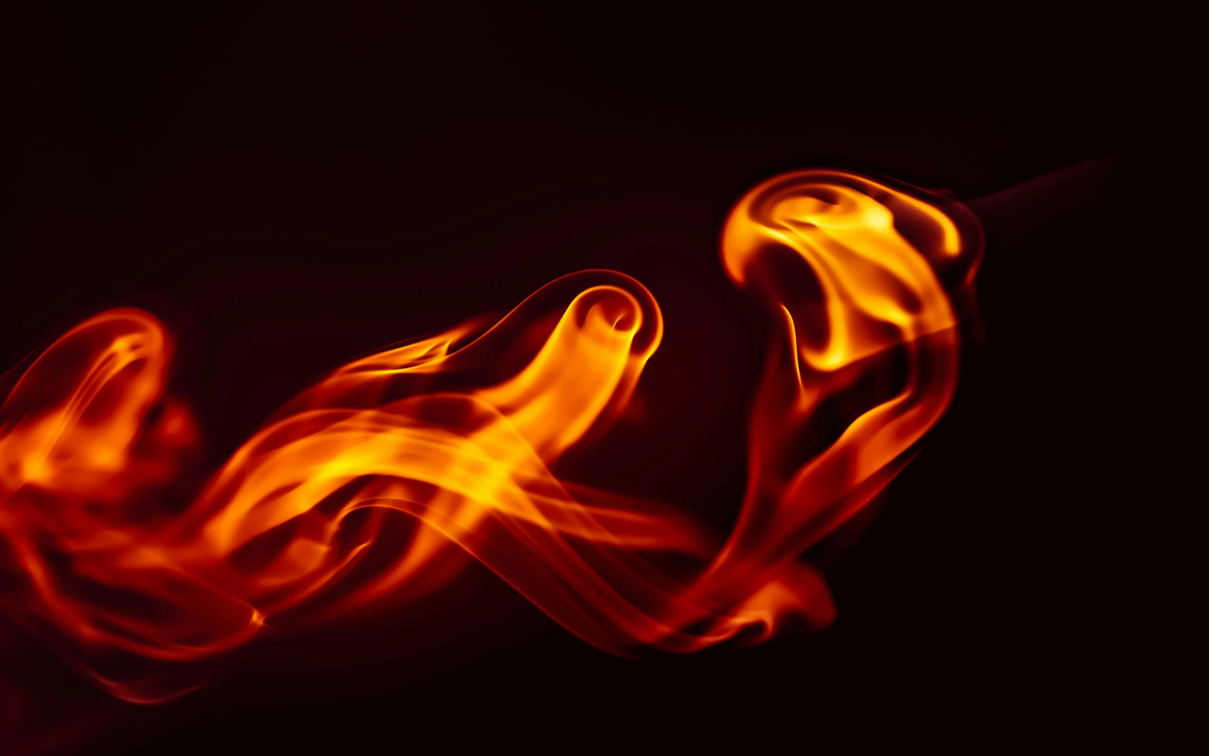 an extreme closeup of some fire with the dark background