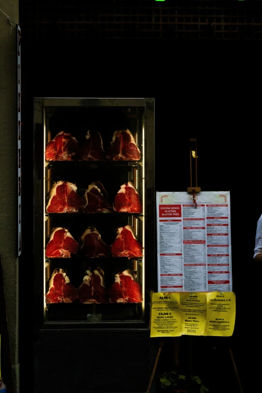 a man is standing next to a rack with food on it