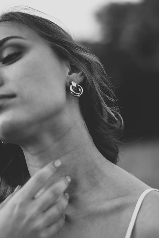 black and white image of woman with large earrings