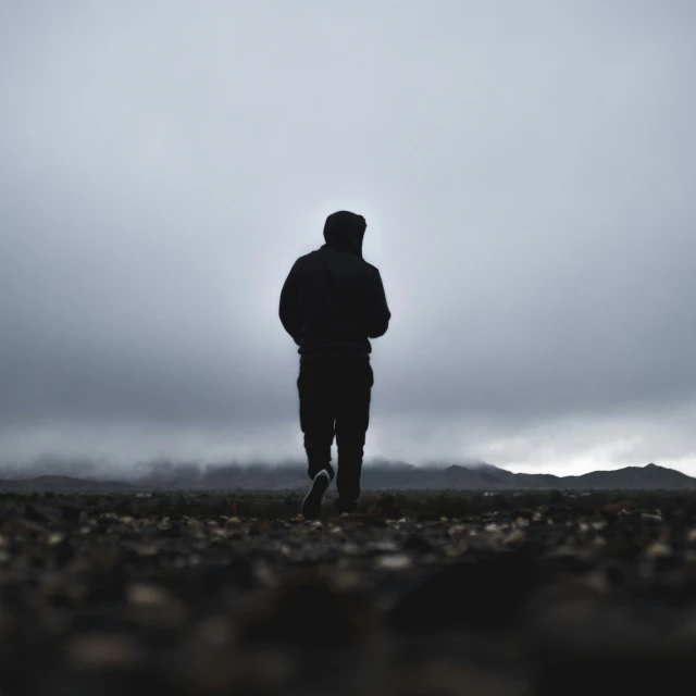 a man is standing alone in a field