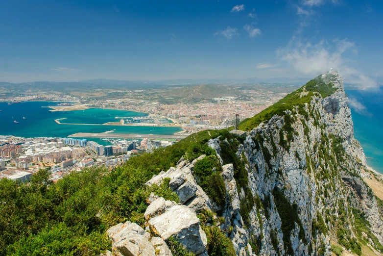 a grassy mountain side on a large body of water