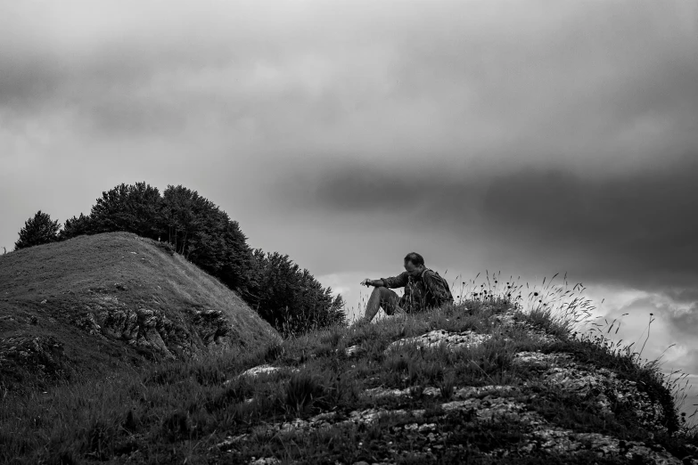 a man sitting at the top of a hill