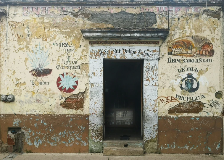 an old building with a doorway in front of a wall