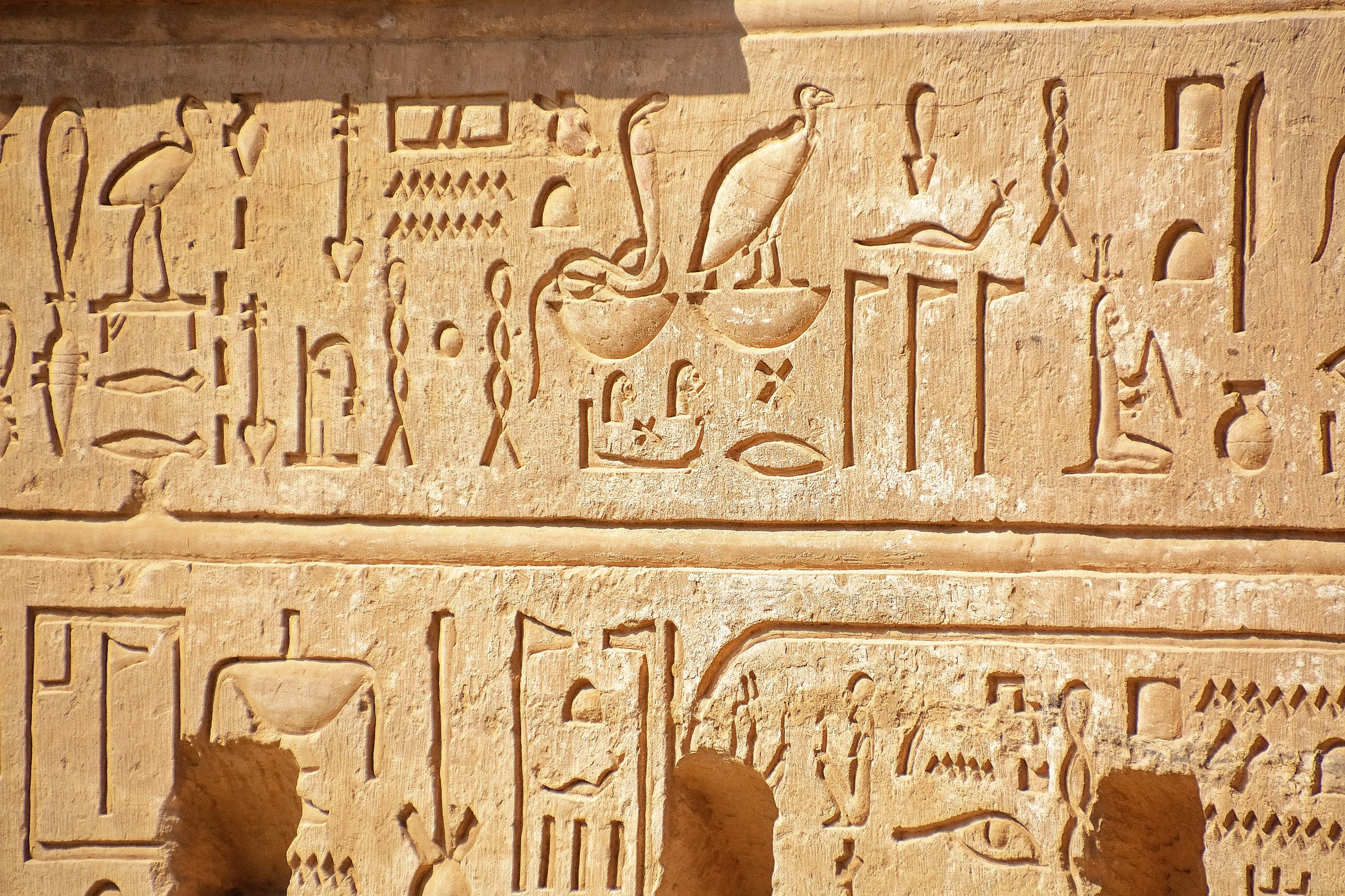 an egyptian style scene with some figures on it