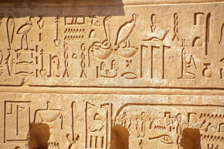 an egyptian style scene with some figures on it