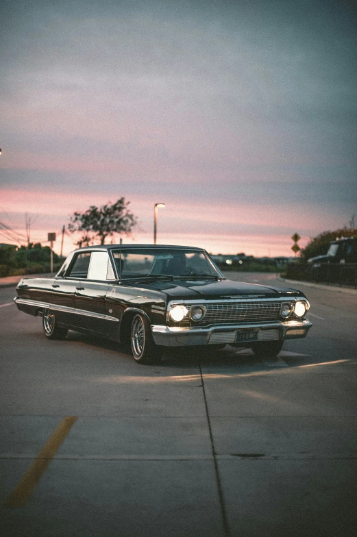 an old classic car parked in the parking lot