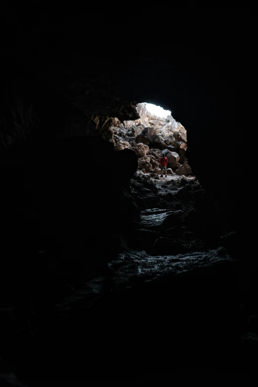 a person walking through a cave in the dark