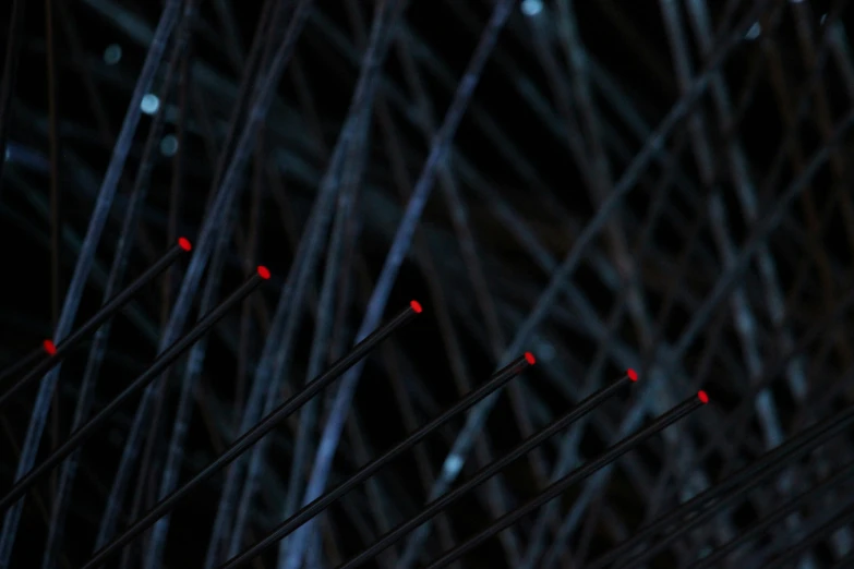 several lights and wires close up against a dark background